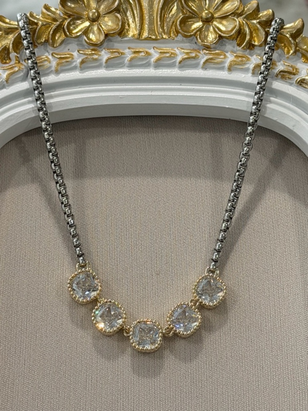 Gold and Rhodium Plated Two-Tone Triple CZ stones.